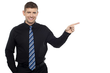 Image showing Cheerful business consultant pointing at the copy space area