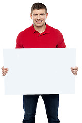Image showing Casual guy presenting ad board