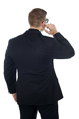 Image showing Bodyguard listening to vital information carefully