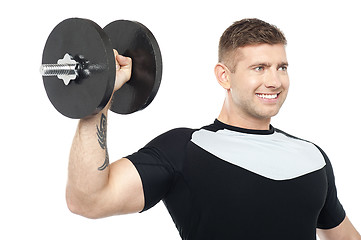 Image showing Muscular male showing his biceps by lifting heavy dumbbell