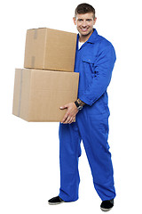 Image showing Young smart relocation staff carrying cartons