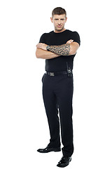 Image showing Bodyguard with tattoo. Posing with folded arms