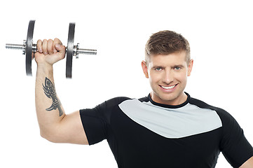 Image showing Male instructor posing with raised dumbbell