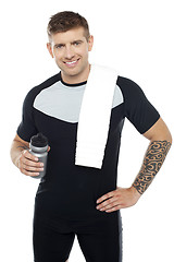 Image showing Energetic fit man holding water bottle