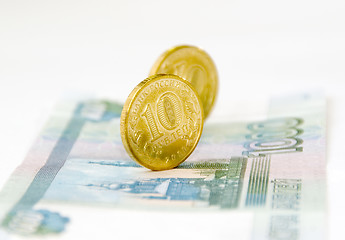 Image showing Two coins on banknote isolated