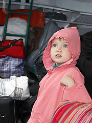 Image showing Little girl among traffic baggage