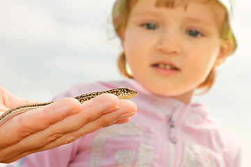 Image showing Little girl watching at the lizard