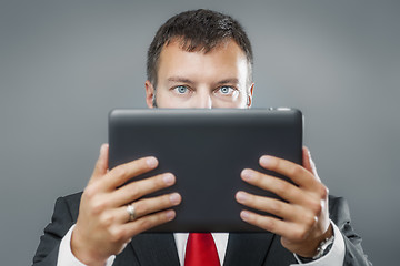 Image showing business man reading tablet pc