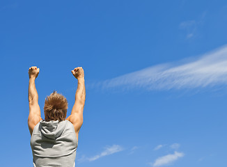 Image showing Sporty guy with his arms raised in joy