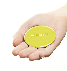 Image showing Hand holding volunteer button