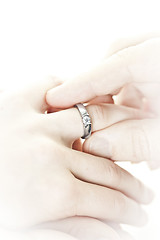 Image showing Man putting engagement ring on finger