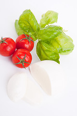 Image showing tasty tomatoe mozzarella salad with basil on white 