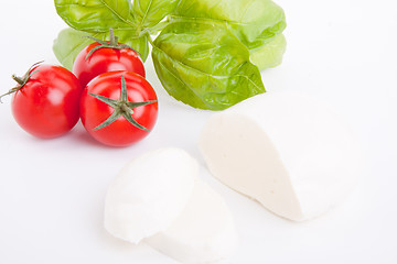 Image showing tasty tomatoe mozzarella salad with basil on white 