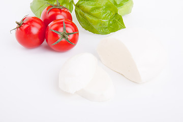 Image showing tasty tomatoe mozzarella salad with basil on white 