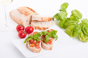 Image showing deliscious fresh bruschetta appetizer with tomatoes isolated