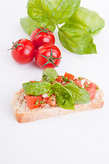 Image showing deliscious fresh bruschetta appetizer with tomatoes isolated