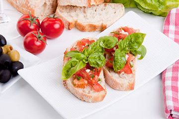 Image showing deliscious fresh bruschetta appetizer with tomatoes isolated