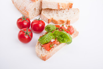 Image showing deliscious fresh bruschetta appetizer with tomatoes isolated