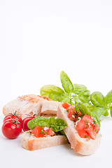 Image showing deliscious fresh bruschetta appetizer with tomatoes isolated