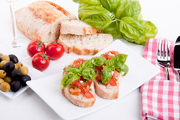 Image showing deliscious fresh bruschetta appetizer with tomatoes isolated