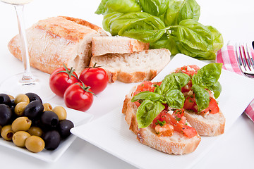 Image showing deliscious fresh bruschetta appetizer with tomatoes isolated