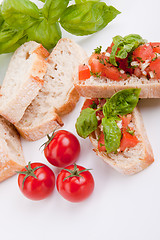 Image showing deliscious fresh bruschetta appetizer with tomatoes isolated