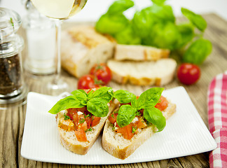 Image showing fresh tasty italian bruschetta with tomato on table