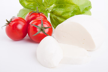 Image showing tasty tomatoe mozzarella salad with basil on white 