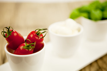 Image showing tasty tomatoes mazarella and basil on plate on table