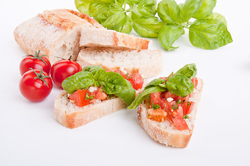 Image showing deliscious fresh bruschetta appetizer with tomatoes isolated