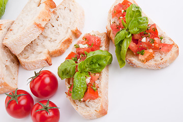 Image showing deliscious fresh bruschetta appetizer with tomatoes isolated