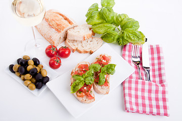 Image showing deliscious fresh bruschetta appetizer with tomatoes isolated