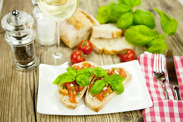 Image showing fresh tasty italian bruschetta with tomato on table