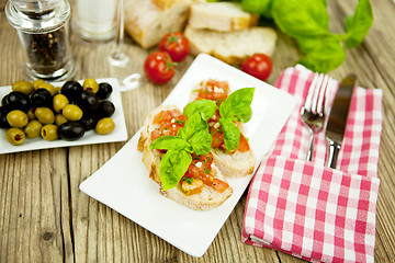 Image showing fresh tasty italian bruschetta with tomato on table