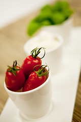 Image showing tasty tomatoes mazarella and basil on plate on table