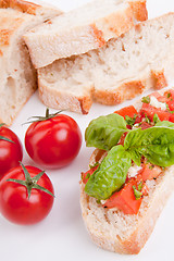 Image showing deliscious fresh bruschetta appetizer with tomatoes isolated