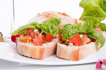 Image showing deliscious fresh bruschetta appetizer with tomatoes isolated