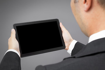 Image showing business man reading tablet pc