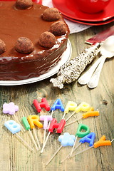 Image showing Chocolate cake and candles in the form of letters.