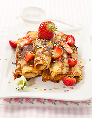 Image showing Rolled crepes with fresh strawberries