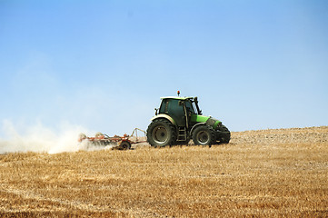 Image showing Tractor plowing field