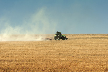 Image showing Tractor plowing field