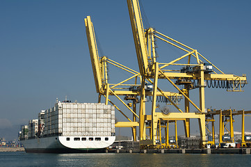 Image showing Freighter in port being loaded with containers