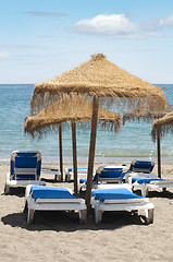 Image showing Straw beach umbrellas and sunbeds