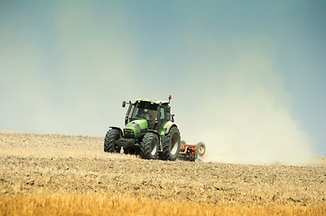 Image showing Tractor plowing field