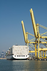 Image showing Freighter in port being loaded with containers