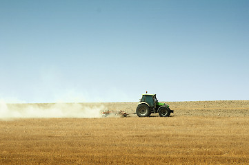 Image showing Tractor plowing field