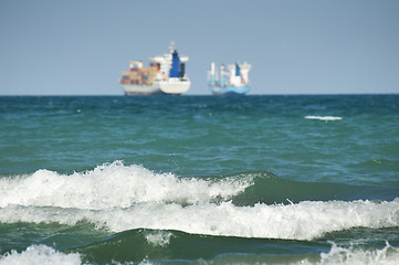 Image showing Commercial container ship on blue sky