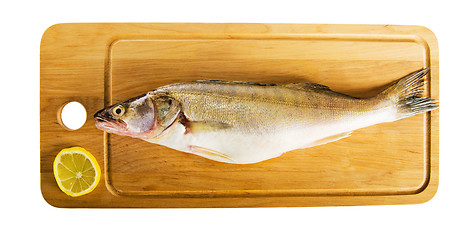 Image showing Pike perch on a wooden kitchen board, it is isolated on white