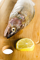 Image showing Pike perch on a wooden kitchen board, it is isolated on white